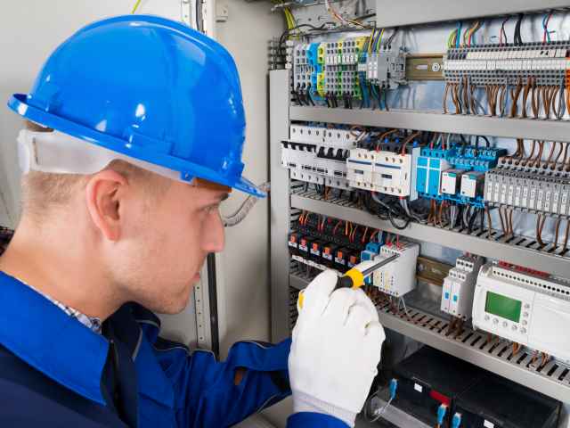 Student works on an electrical panel.