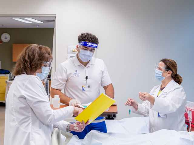 A Seminole State nursing student receives instruction from nursing faculty.