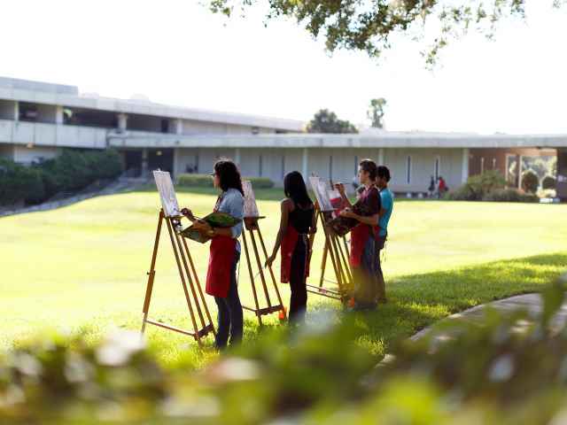 Seminole State art students practice their painting techniques in natural light.