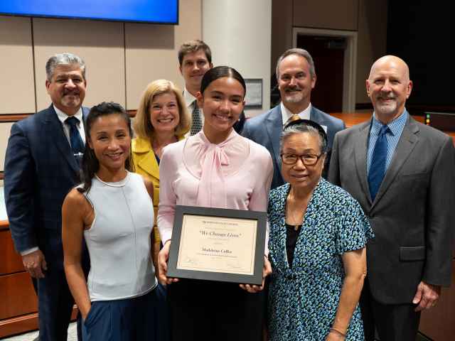 Madeleine Coffee, center, with her mother and grandmother, was recognized with the We Change Lives award at Seminole State's August 2025 Board of Trustees meeting.