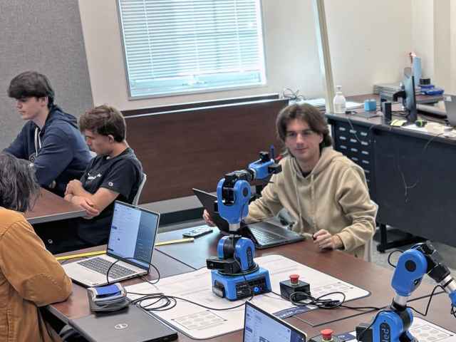 Students studying engineering technology at Seminole State train with high-tech robotic arms.