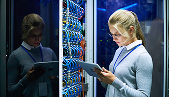 A lady working on a laptop in a networking room
