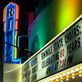 The Ritz sign advertising the Seminole Choir Concert on a black background