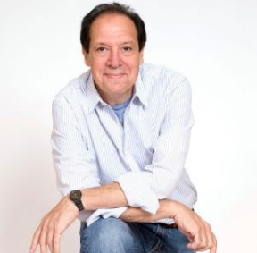 Ken Ludiwg wearing a white shirt and jeans
