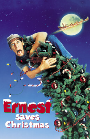Ernest Saves Christmas official movie poster; Ernest is hanging onto a Christmas tree, trying not to fall.