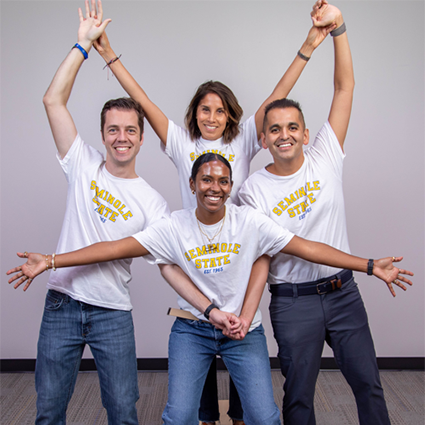 Phillip Martin, Renato Monsalve, Diamond Mcmillan, and Eve Hudson standing together and smiling at the camera