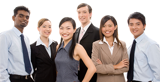 Group of students wearing business attire, posing for photo against a white background