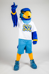 Rally standing with his right hand in a fist with his index finger extended