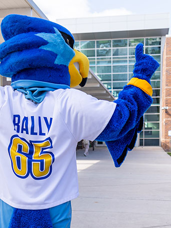 Rally posing for the camera with his back facing and a finger up